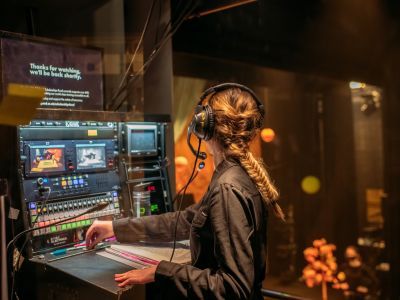 Deputy Stage Manager at a cueing desk on a production